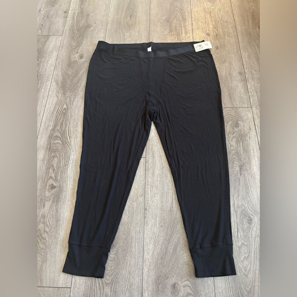 Stars above woman’s ribbed  knit pajama pants